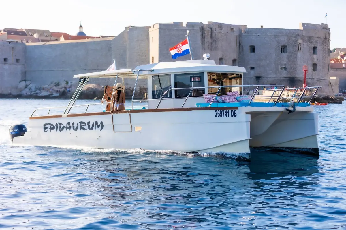 Epidaurum catamaran in front of the Old Port walls