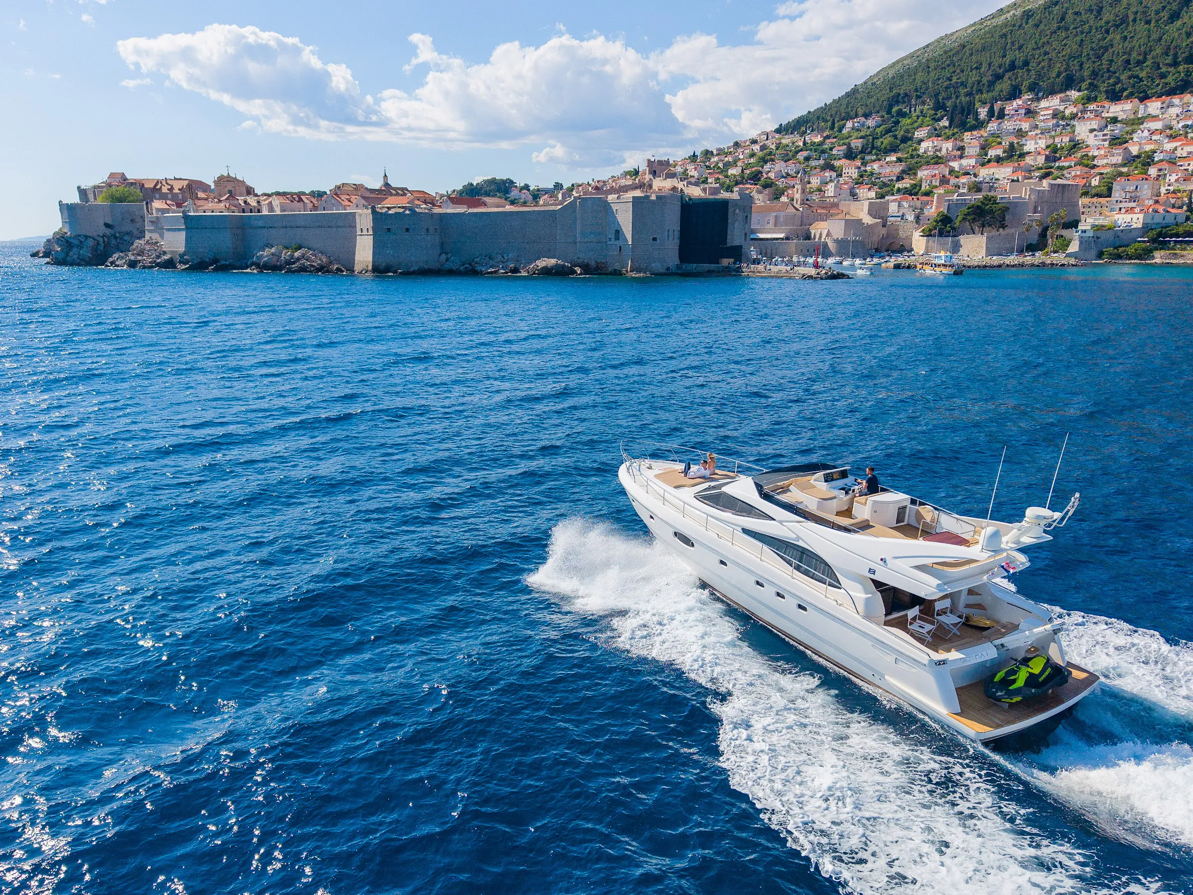 Motor yacht heading out from Dubrovnik on a sunny day