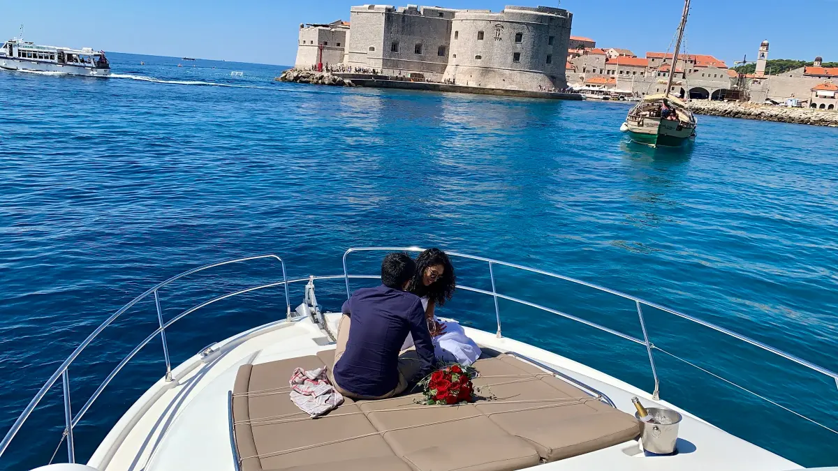 Couple on the bow of a yacht facing Dubrovnik's Old Port