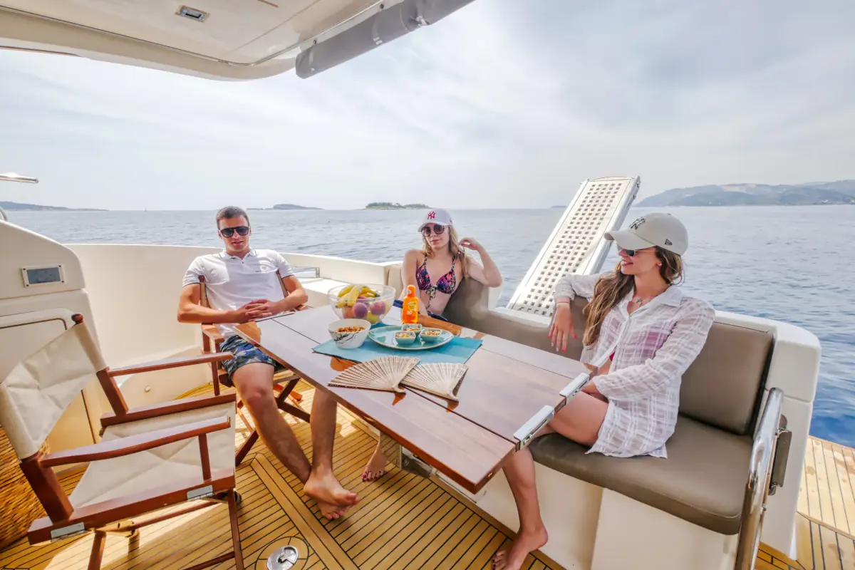 Guests having lunch at the aft-deck table of a yacht
