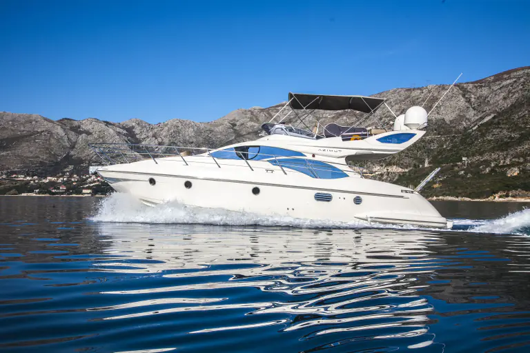 Azimut 43 Fly underway with mountains behind