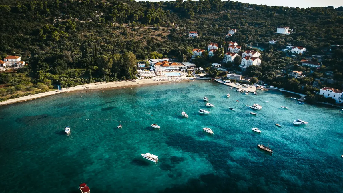 Boats on the turquoise water of a Koločep bay