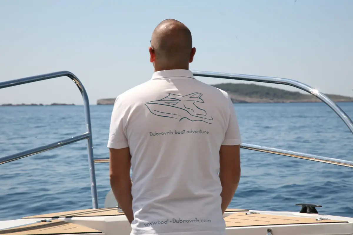 Skipper in a Dubrovnik Boat Adventure T-shirt looking out to sea