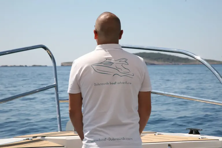 Skipper in a Dubrovnik Boat Adventure T-shirt looking out to sea