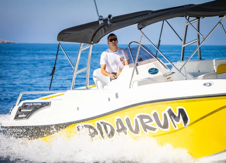 Skipper at the wheel of an Epidaurum speedboat
