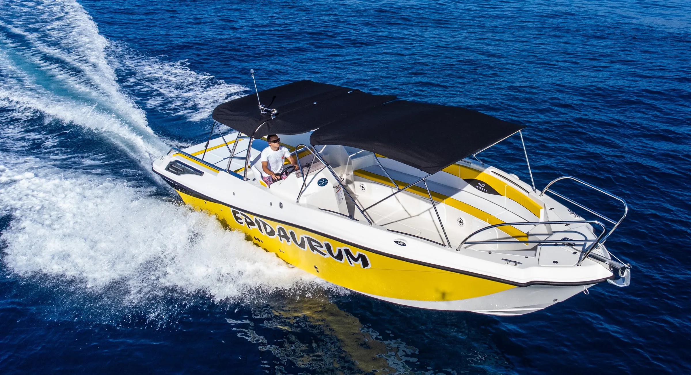Yellow and white Epidaurum speedboat on the open sea