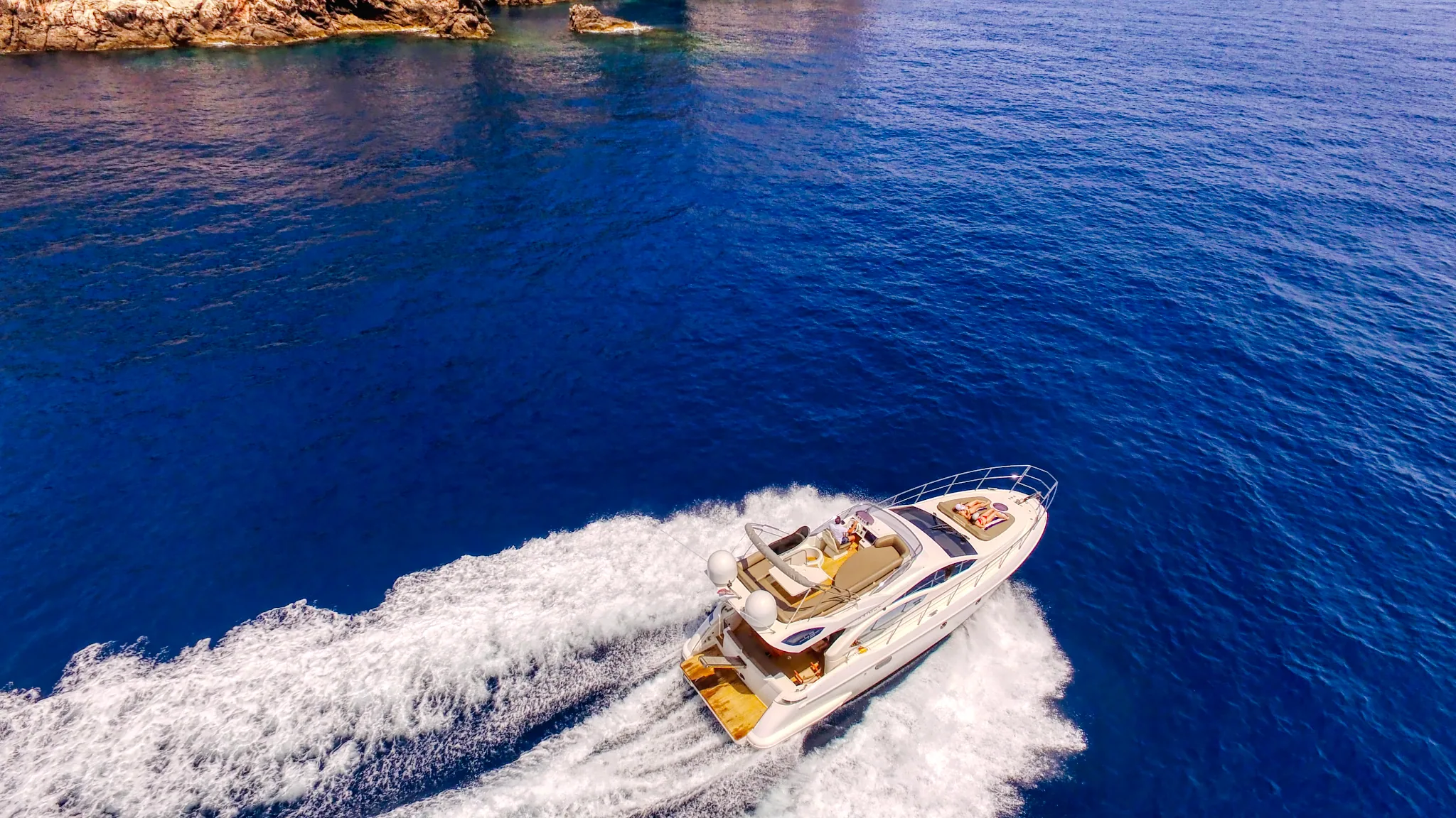 Speedboat on deep blue water, seen from above