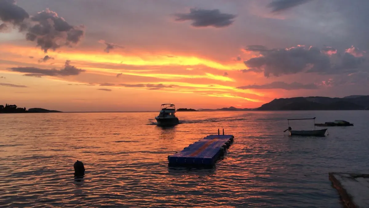 Sunset over the sea off Dubrovnik with a boat at anchor