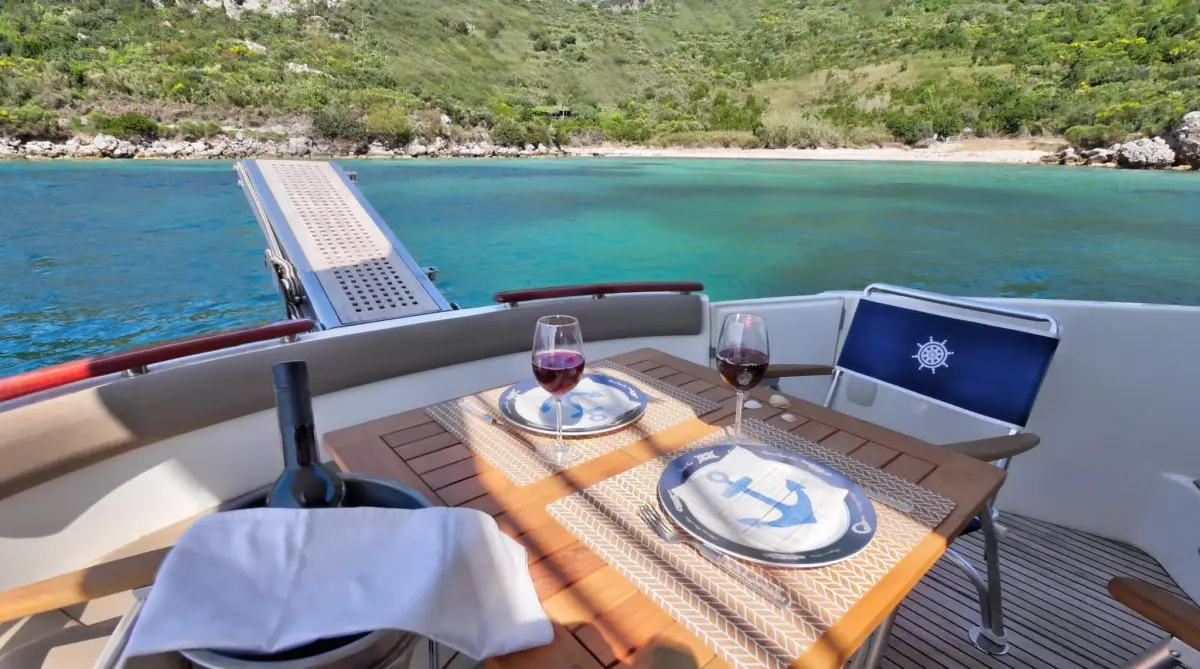 Table set on the aft deck over turquoise water